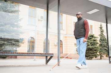 Fototapeta premium African american man navigating city street with cane