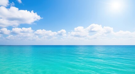Fototapeta premium A breathtaking view of a peaceful turquoise sea meeting the clear blue horizon under a bright sun with fluffy white clouds floating above, scenic, clouds, vacation