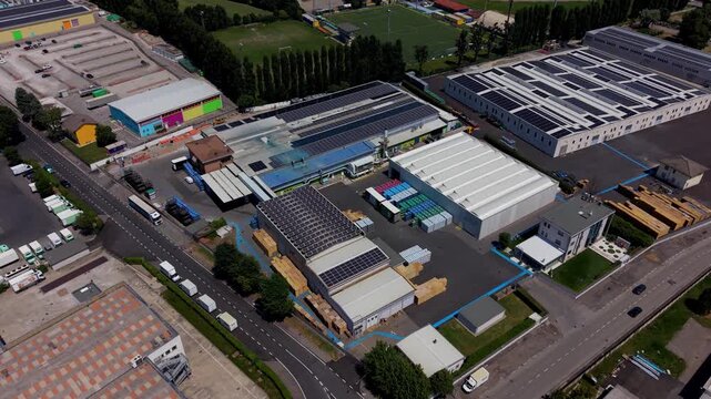 Industrial Zone Aerial View: An expansive aerial view showcases a sprawling industrial zone filled with various warehouses, manufacturing plants, and logistic facilities, bustling with activity.