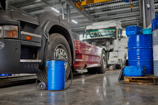 The image captures several trucks featuring elevated cabs in a maintenance area, illustrating how these designs facilitate easier access for servicing large vehicles effectively.