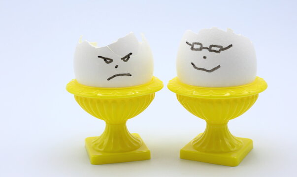 Hand drawn angry and happy face. Egg photo. Concept of expesive egg prices. 