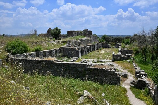 Ancient ruins of Miletus with modern wind turbines on the hills in Turkey