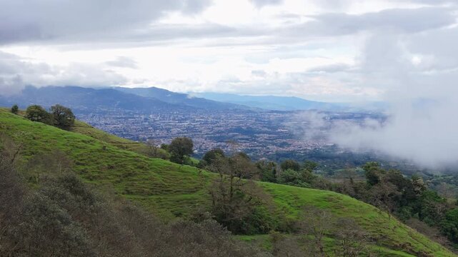 Drone reveal shot of San Jose city view from the green mountains of Coronado, Costa Rica