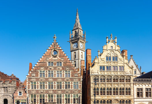 Medieval architecture of Graslei quay at Lys (Leie) river with Clock tower of former Post Office, Ghent, Belgium