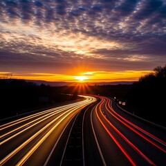 Obraz premium Streaking headlights & taillights on highway at sunset, dramatic sky