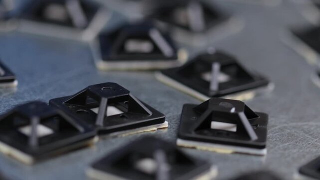 Plastic self-adhesive pad for installing nylon ties.