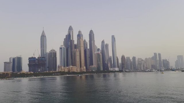 Panoramic view of the Dubai Marina skyline and luxury high rise skyscrapers from the sea at Jumeirah Beach Residence, UAE.