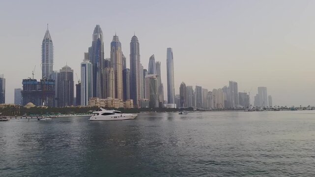 Panoramic view of the Dubai Marina skyline and luxury high rise skyscrapers from the sea at Jumeirah Beach Residence, UAE.