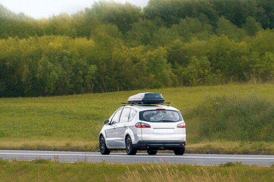 Automobile with Roof Rack Traveling in Rural Nature