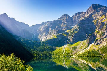 landscape with lake in mountains. scenic nature of poland with rocky summit reflection on the lake surface in summer. view of wonderful place in high tatra mountains for travel in eastern europe © Lesia