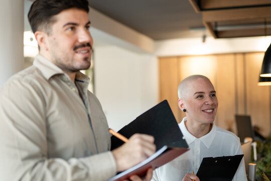 Business people taking notes during office meeting