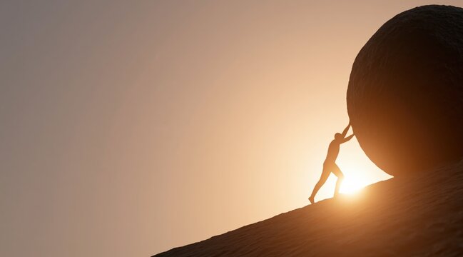 Silhouette of person pushing large rock uphill against sunset