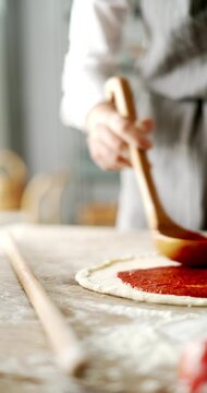 Close up of woman hands preparing pizza in kitchen