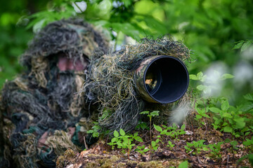 Wildlife photographer in the summer ghillie camouflage suit © byrdyak