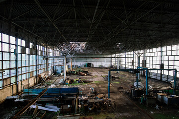 Fototapeta premium Old ruined factory building overgrown by green moss and plants