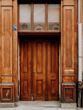 Ornate Vintage Wooden Double Door with Fluted Pilasters and Transom Window