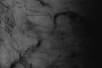 Dark, textured concrete background with abstract black scratch marks © Rawpixel.com