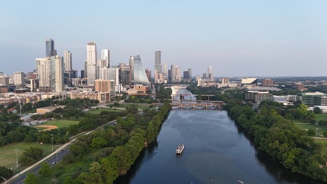 Downtown Austin looking east while hovering over the Colorado River, also known as Lake Austin at this point. And also known as Town Lake or ladybird Lake in the central part of the city. 