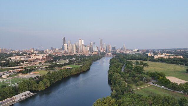 Downtown Austin looking east while hovering over the Colorado River, also known as Lake Austin at this point. And also known as Town Lake or ladybird Lake in the central part of the city. 