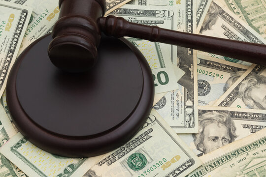 Judge gavel and block and on twenty dollar bills for legal fees and court costs