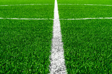 Obraz premium Football green field with white line at the middle. Sport background concept.