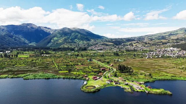 Scenic aerial shot of yahuarcocha lake in ecuador with the majestic imbabura volcano in the background