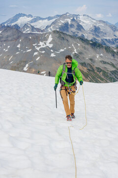 Man walking over crevasse, glacier