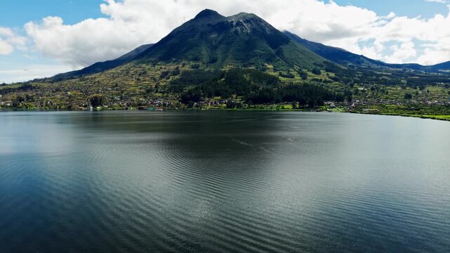 Scenic aerial footage of the imbabura volcano and yahuarcocha lake in ecuador on a sunny day