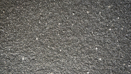 Rough black textured desktop wallpaper with a gritty asphalt-like surface. © Rawpixel.com