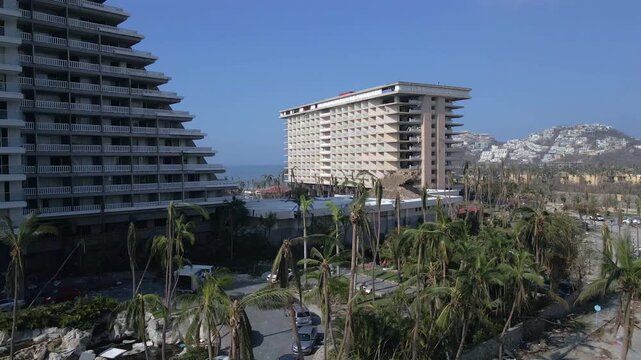 Acapulco, Guerrero, Mexico - October 30 2023: Aerial drone footage showing damaged hotels, destroyed palm trees and urban destruction after Hurricane Otis impacted the coastal tourist city of Acapulco