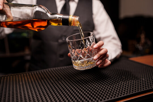 Bartender Pouring Whiskey into a Glass