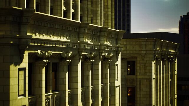 Golden evening light highlights detailed architectural features in cityscape. Twilight casts warm glow over vintage facades and ornate architectural elements