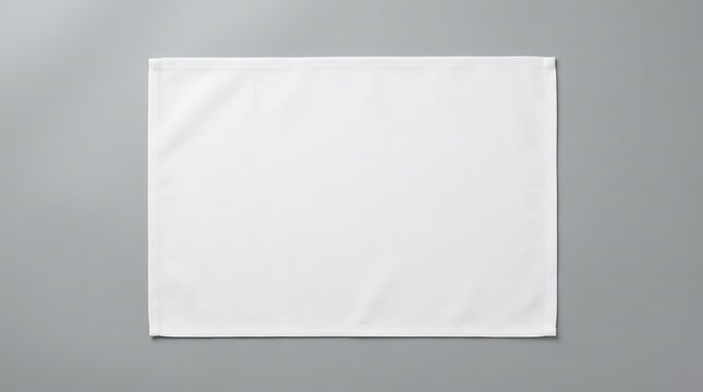 Isolated empty rectangular white fabric placemat mockup centered on flat grey surface for restaurant menu or tabletop presentation