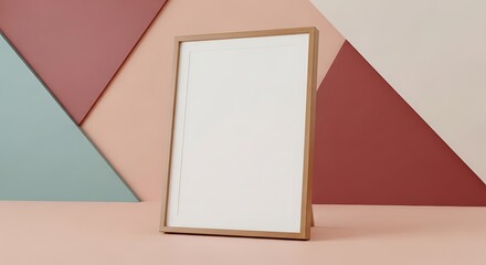 Fototapeta premium Blank wooden picture frame mockup standing on table against geometric pastel wall backdrop for display