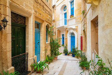Cozy street and traditional colorful wooden balconies in Birgu, Malta © Olena Zn