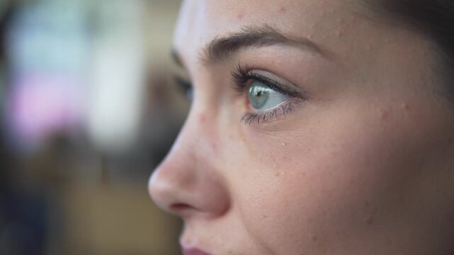 Close-up portrait of beautiful woman focused gazeing with captivating green eyes