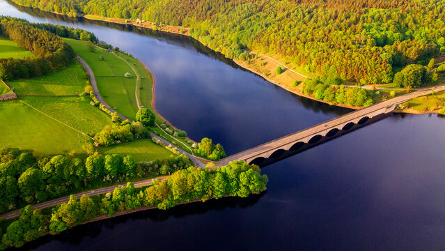 Aerial view of Ladybower Reservoir bridge surrounded by green forests