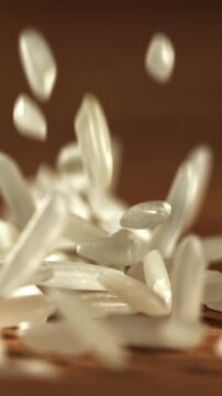 Rice falls on a wooden table. Filmed on a high-speed camera at 1000 fps. High quality FullHD footage