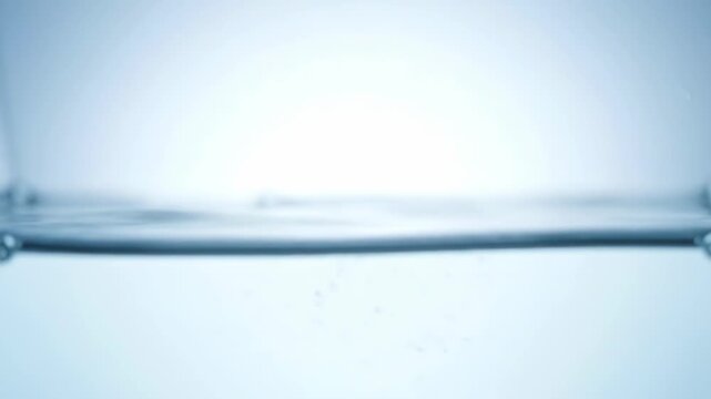 Close up water droplet with soft blue ripples