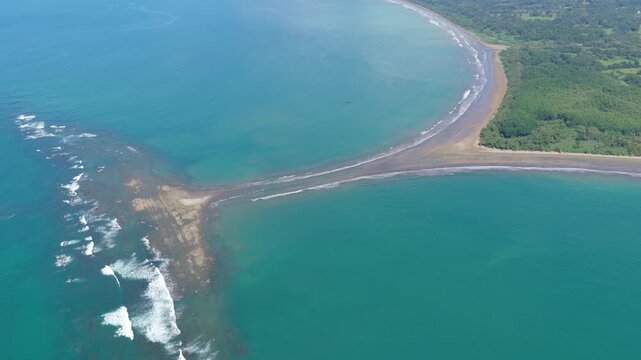 Breathtaking aerial footage of the famous whale tail shaped tombolo at Marino Ballena National Park in Uvita, Puntarenas, Costa Rica