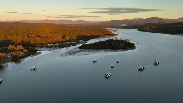 Aerial drone view of Batemans Bay on the NSW South Coast, Australia, rotating from a view of Clyde River to the CBD and coastline on a sunny early morning in May 2026   