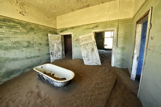 Desert sand in the ruined building of the former diamond city, ghost town, Kolmanskop, L&uuml;deritz, Namibia