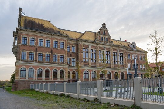 Imposing building with brick walls, large windows and fenced-in courtyard, St. Augustin Grammar School, Grimma, Leipzig, Saxony, Germany