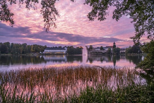 Lake Burgsee, Burgseeklinik hospital and the Old Town at dusk, Bad Salzungen, Thuringia, Germany