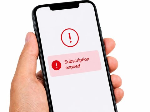 Hand holding smartphone with subscription expired notification on screen. Digital alert warning about payment failure