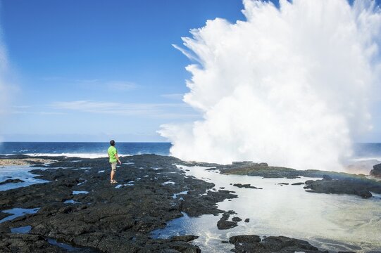 Tourist enjoying the huge waves in the Alofaaga blowholes on the south of Savai&acute;i, Samoa, South Pacific