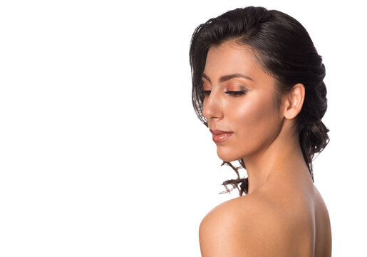 Beautiful young woman with tanned skin and professional makeup. Spa, wellness and skin care.