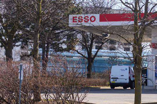 Esso Signage in Toronto with Company Vehicles present