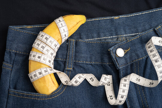 Banana with measuring tape on jean trousers, penis health.