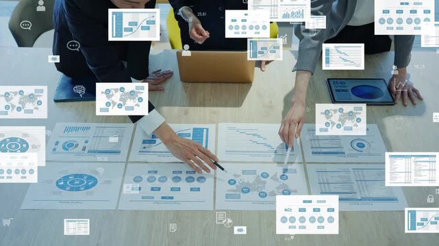 A group of male and female business professionals in a meeting and the concept of digital data
